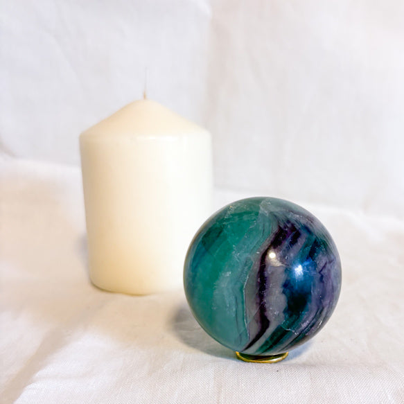 Fluorite crystal polished sphere with rainbow inclusions 330g