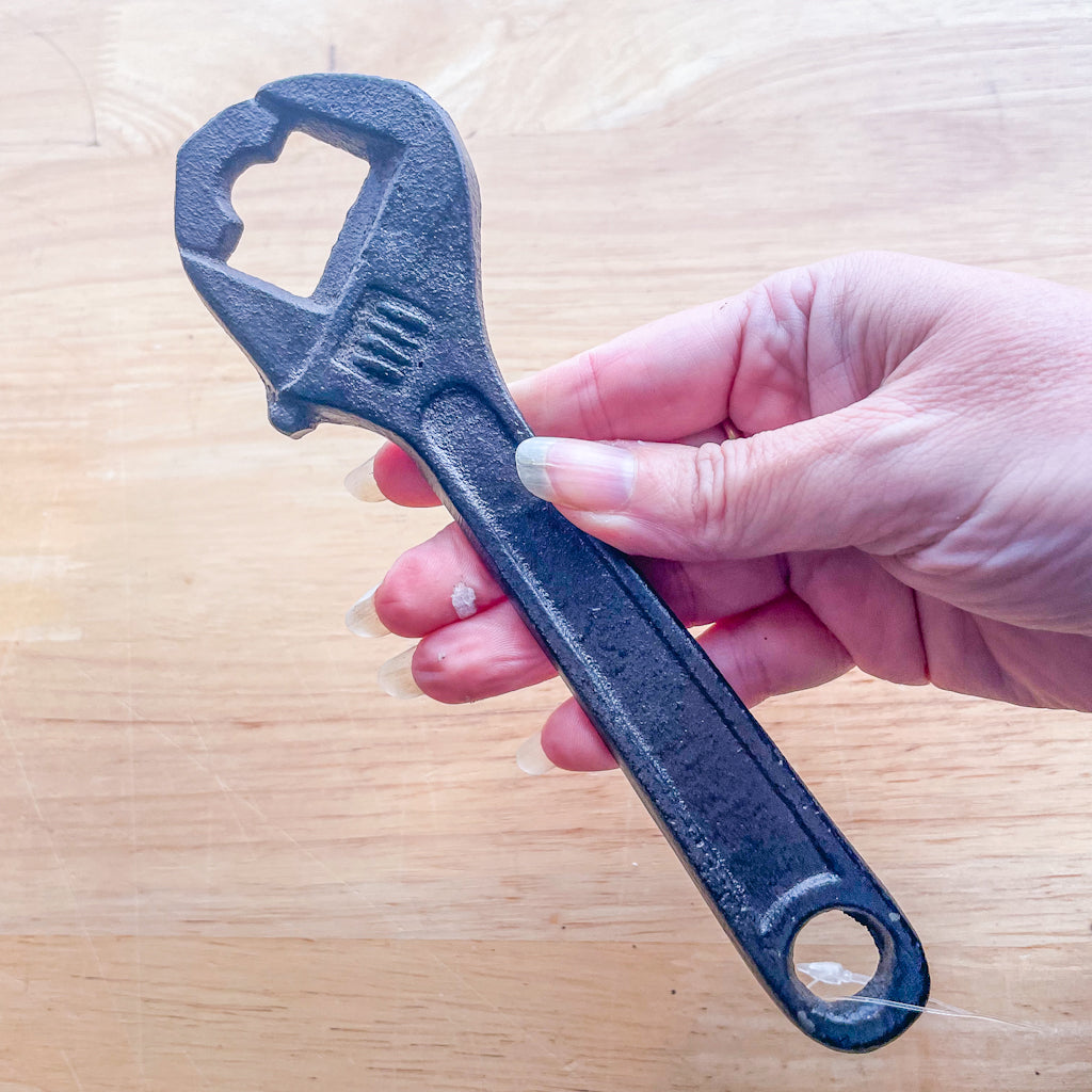 Cast iron bottle opener tool wrench