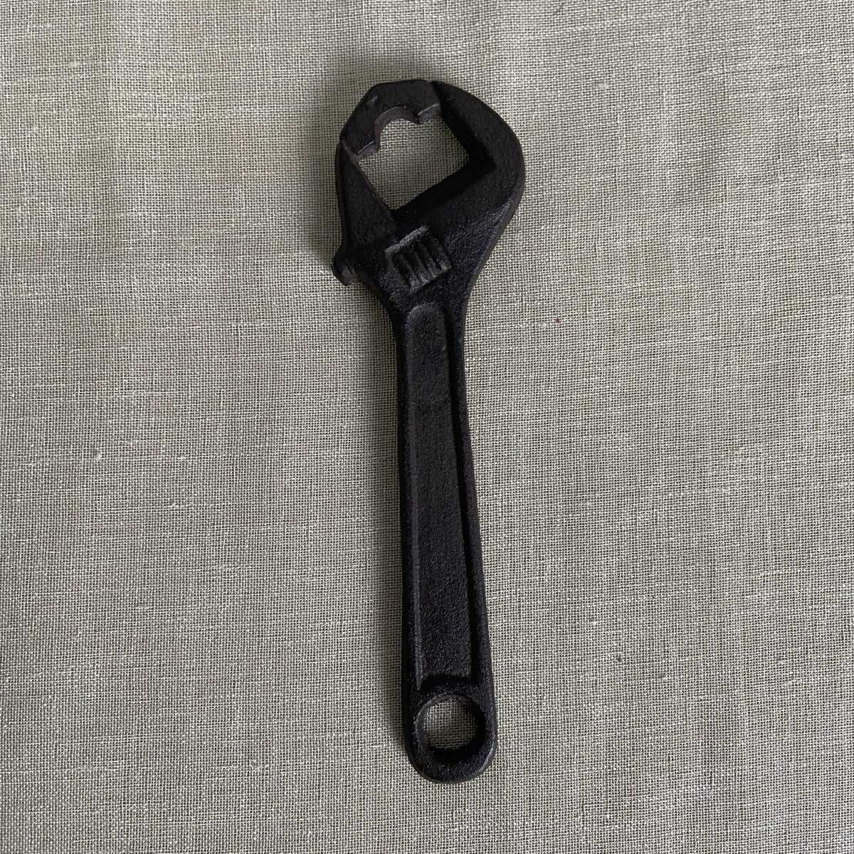 Cast iron bottle opener tool wrench