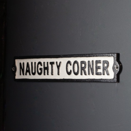 Naughty corner cast iron wall sign