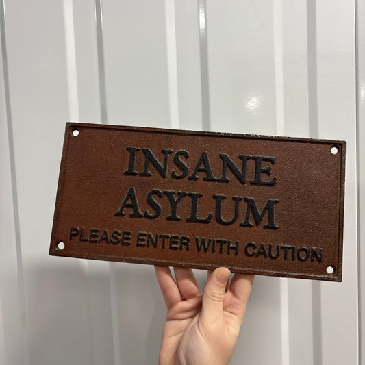 Insane asylum wall hanging rusty metal sign