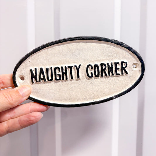 Naughty corner cast iron wall sign