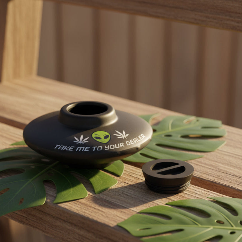 Black silicone pipe with marijuana leaf and alien design on a white background