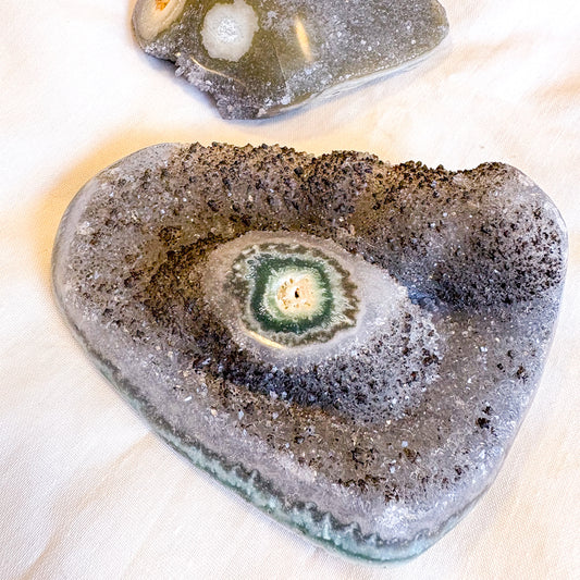 Polished edge amethyst with stalactite eye crystal cluster