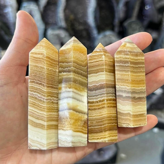 Banded orange calcite crystal point tower