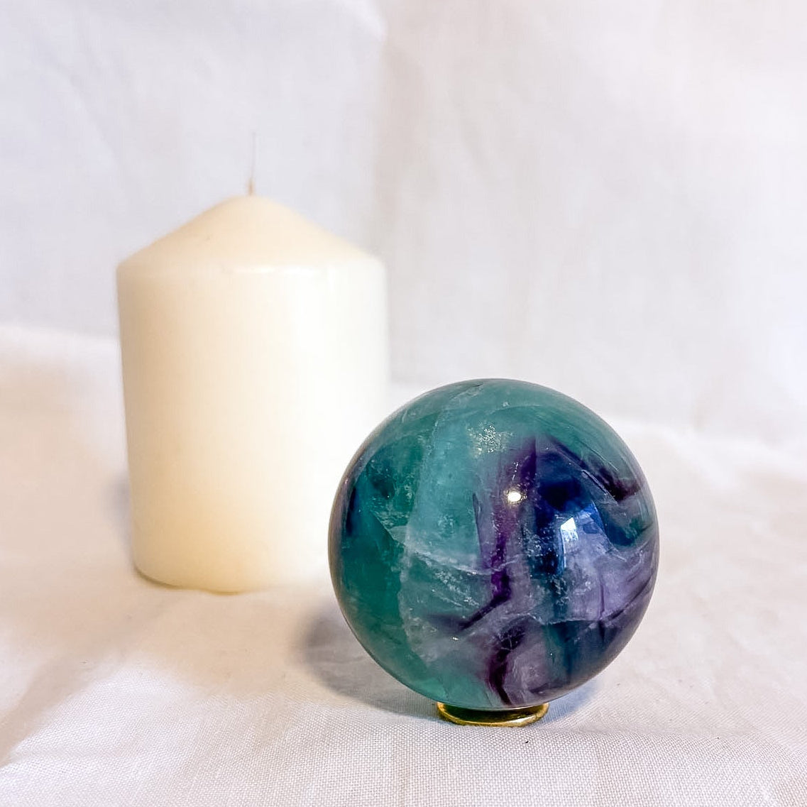 Fluorite crystal polished sphere with rainbow inclusions 330g