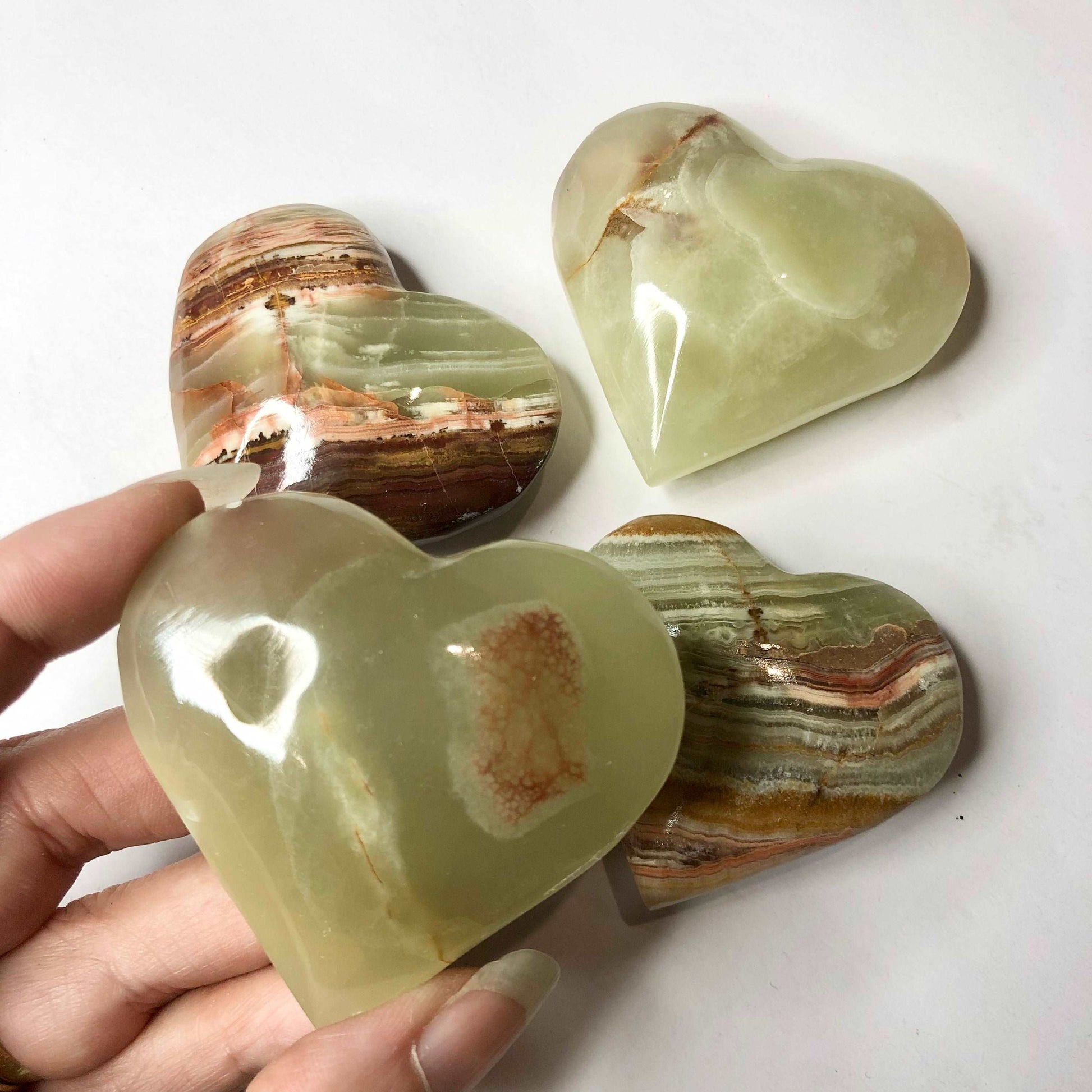 Banded green onyx crystal polished heart shaped palm stone
