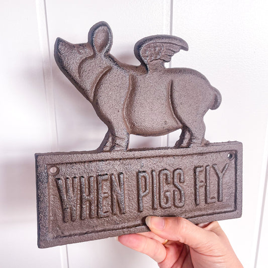 When pigs fly cast iron sign