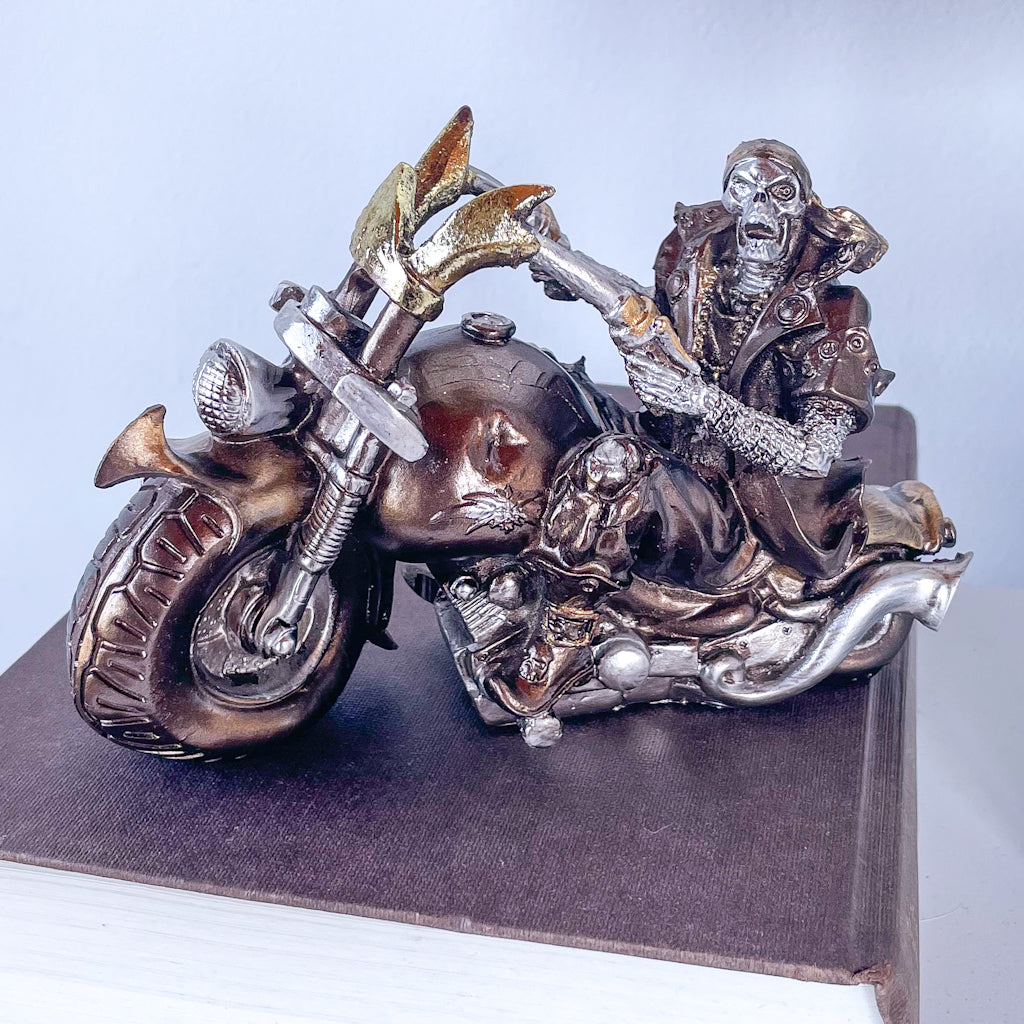 Skeleton on a motorbike skull statue