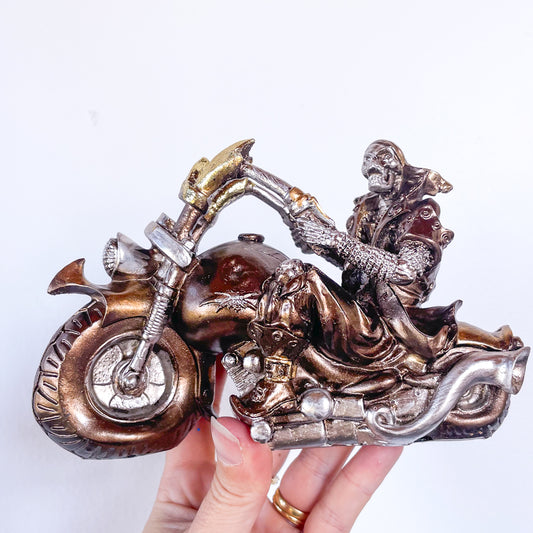 Skeleton on a motorbike skull statue