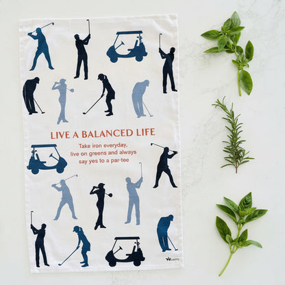 Tea towel with golf-themed design and motivational quote on a white background