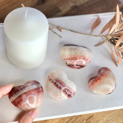 Medium pink banded calcite puffy heart shaped crystal