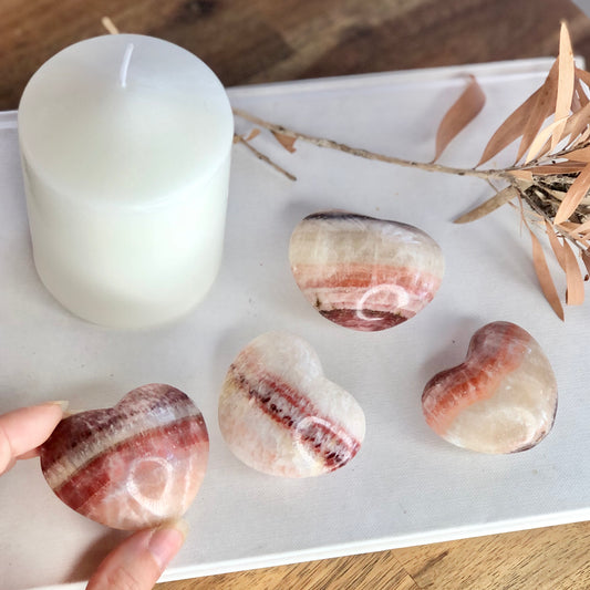Medium pink banded calcite puffy heart shaped crystal