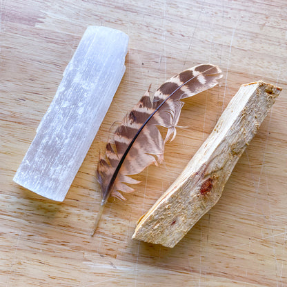 Palo santo wood incense smudge stick, crystal and feather bundle