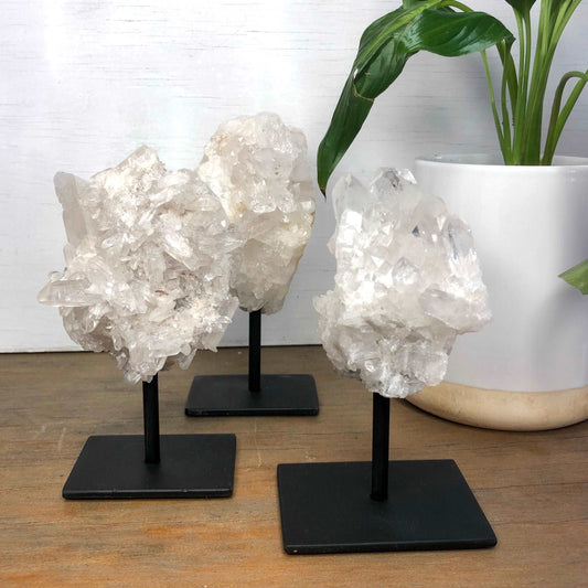 Clear quartz crystal cluster with statue stand - various
